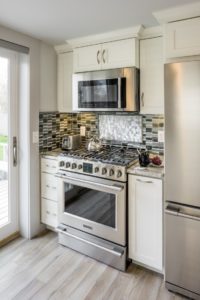 Kitchen Remodeling - Stove countertop with tile backsplash - Exodus Construction - luxury coastal homes